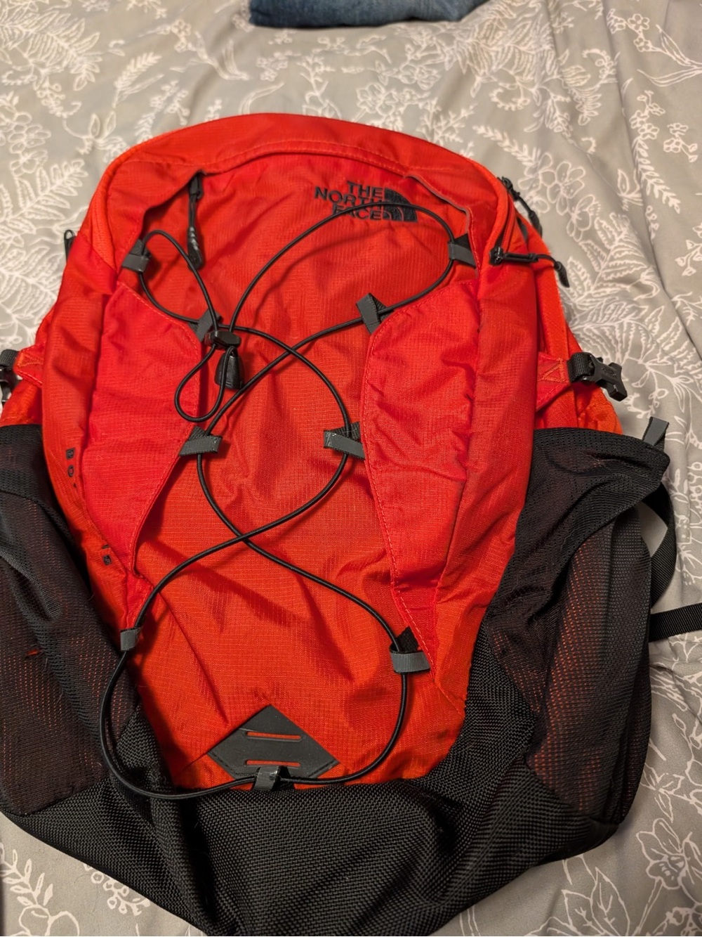 The North Face Orange and Black Backpack with Front Bungee